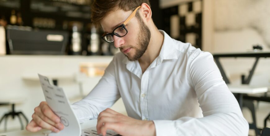 Businessman choosing from menu in restaurant