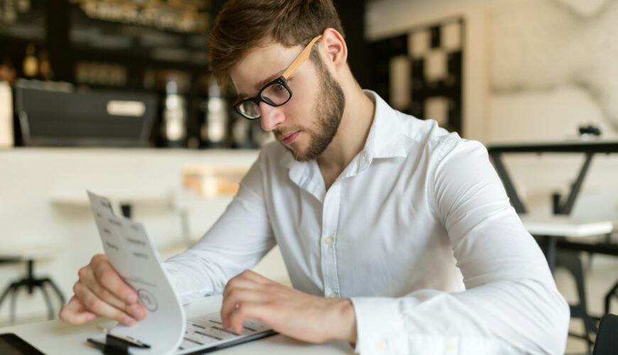 Businessman choosing from menu in restaurant