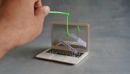 Closeup image of laptop and fish hook with text PERSONAL DATA.