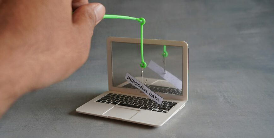 Closeup image of laptop and fish hook with text PERSONAL DATA.