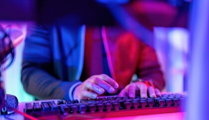 hacker wearing hood jacket typing computer keyboard to phishing steal attack