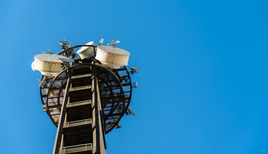 Large telecommunications tower full of radio and television broadcast antennas.